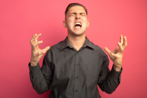 Man expressing anger and frustration, highlighting the importance of managing emotions and stress for men’s mental health